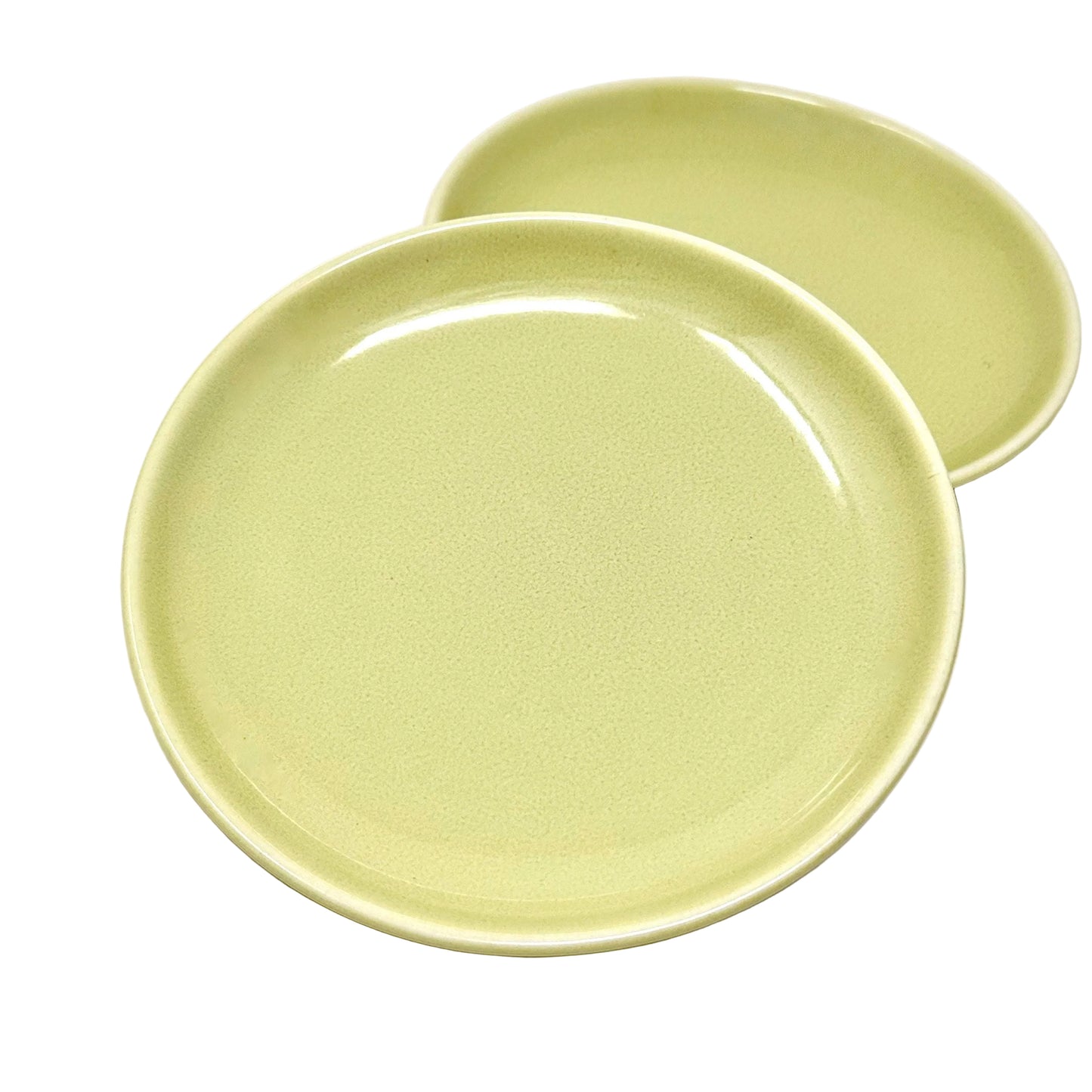 Two light green ceramic plates on a white background