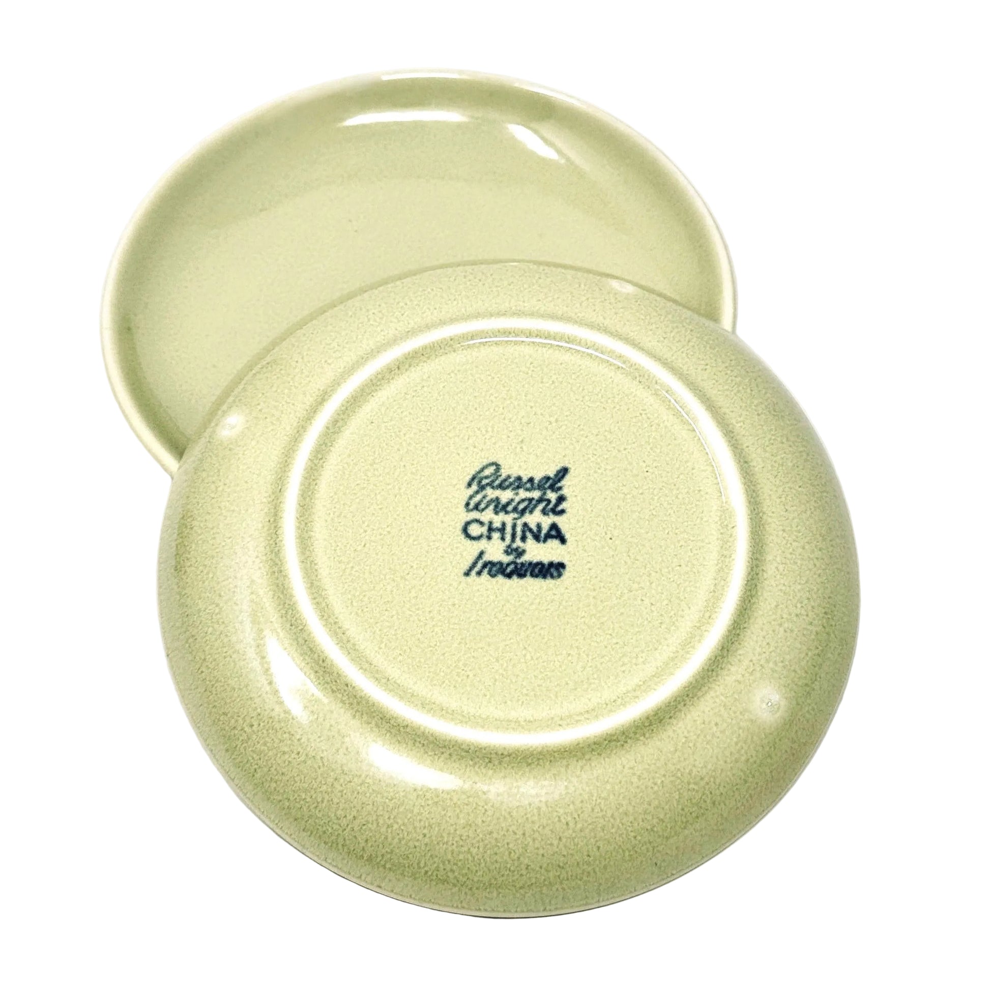 Two green ceramic plates with 'Russell Wright China' branding on a white background