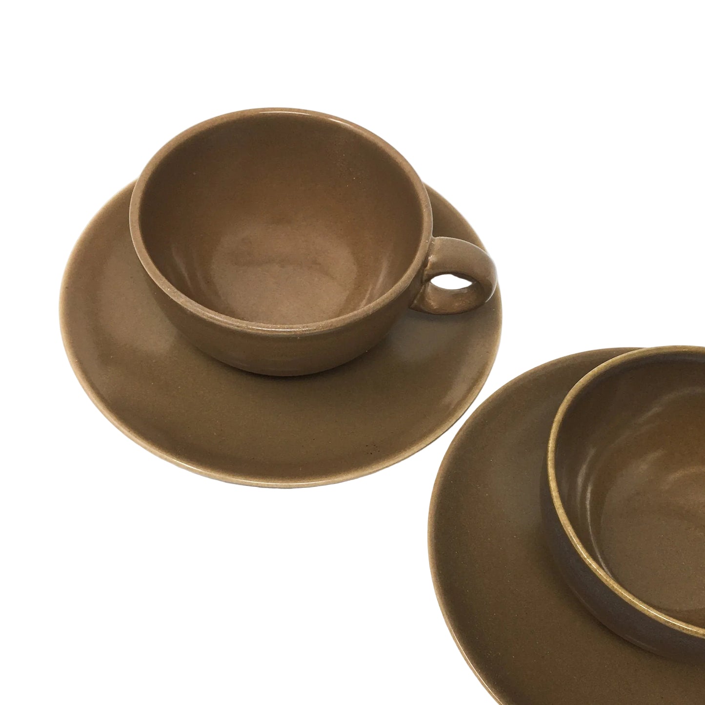 Brown ceramic cup and saucer set on a white background