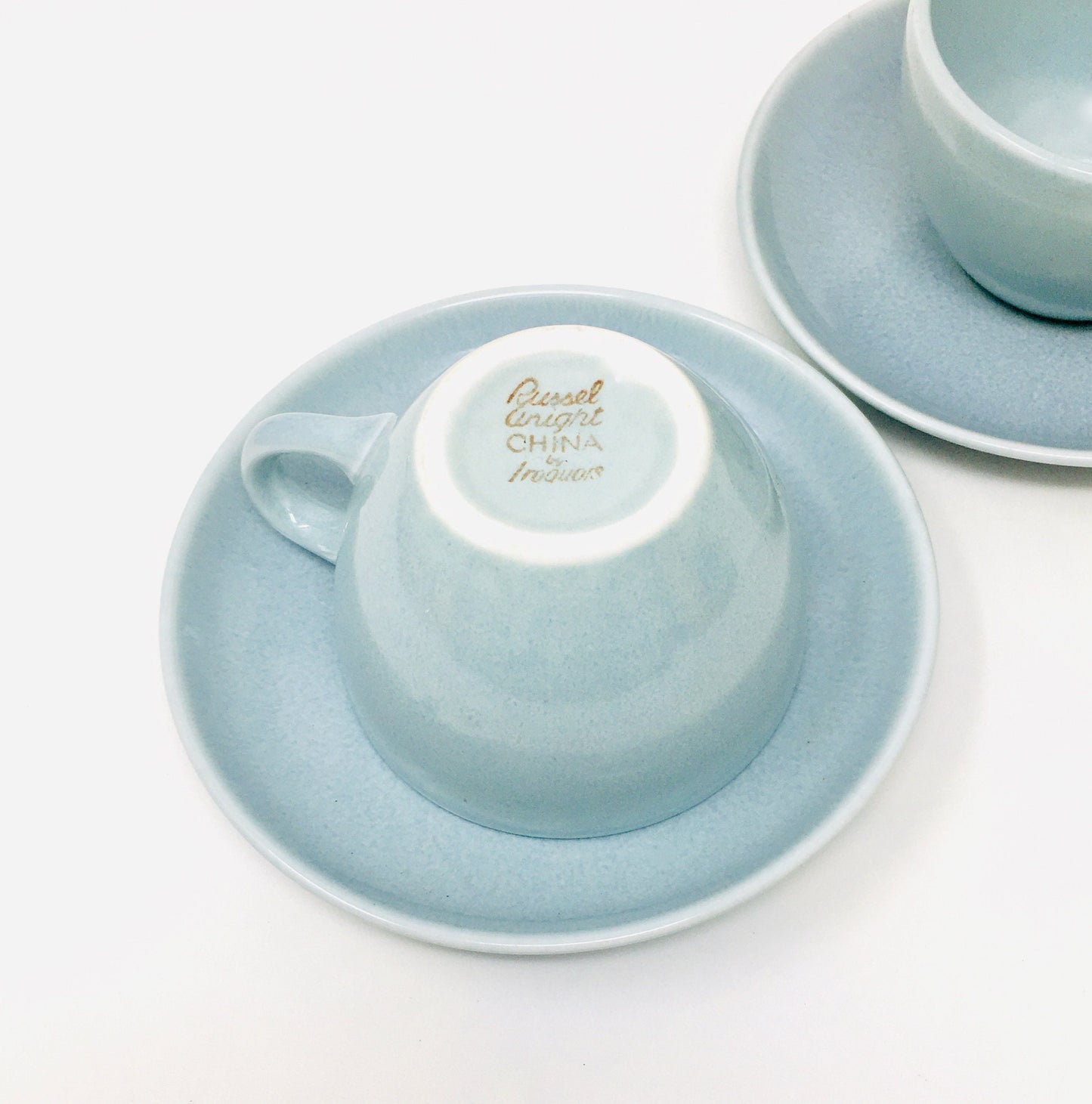 Light blue ceramic teacup and saucer set on a white background