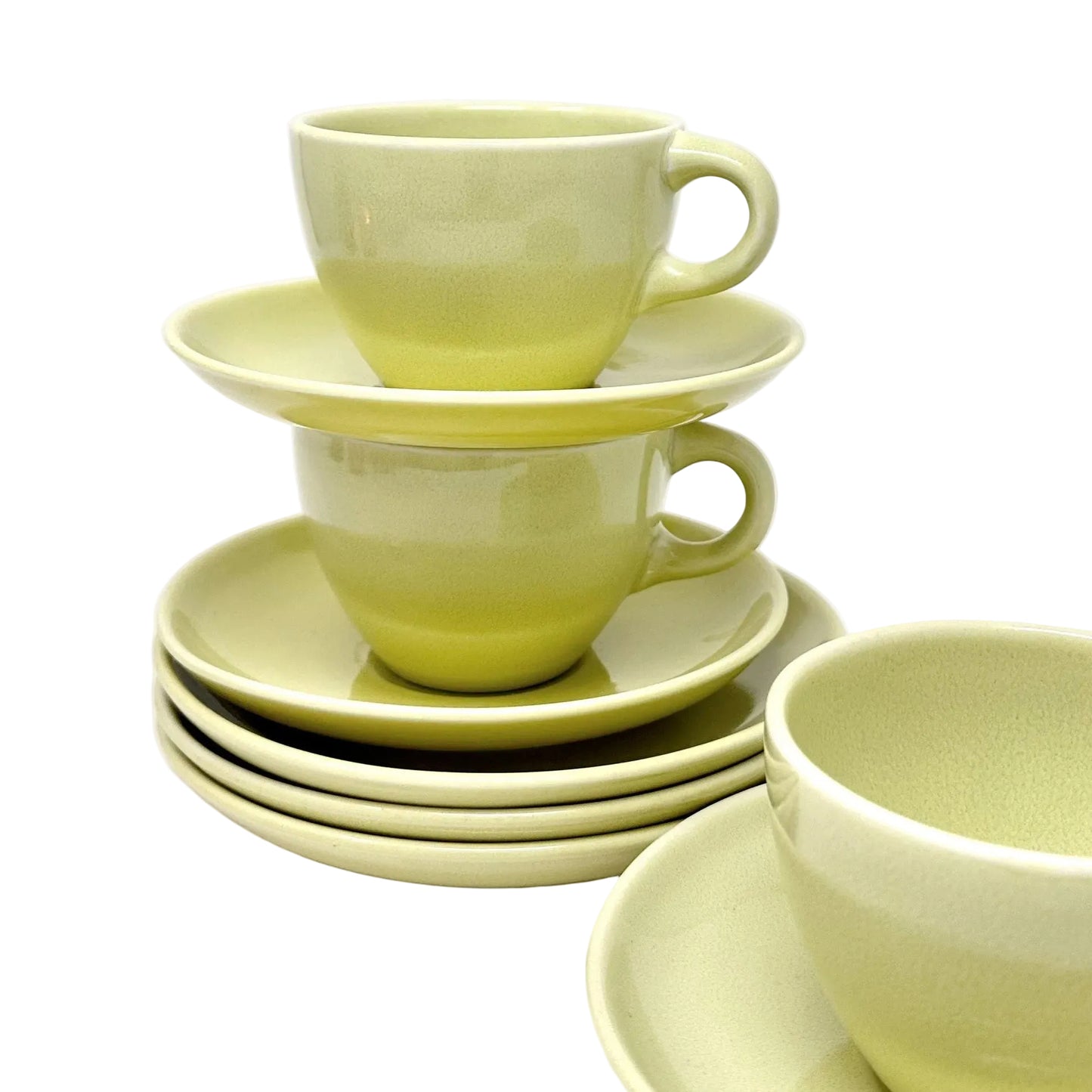 Set of green ceramic cups and saucers on a white background